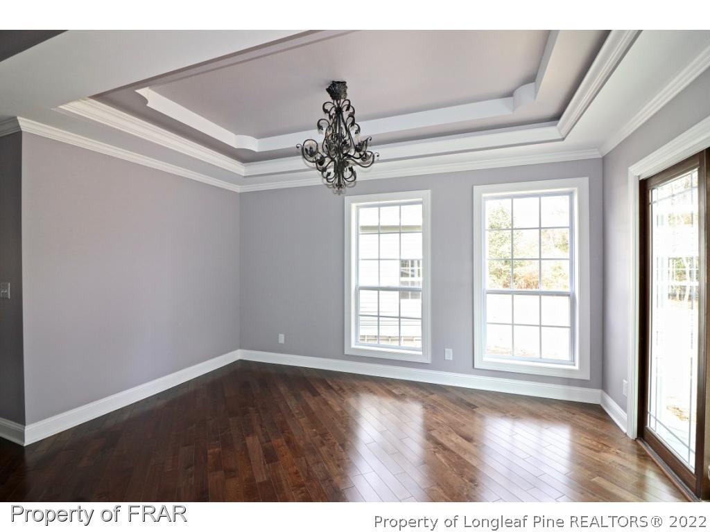 873 Morrison Bridge Road Vass, NC 28394 - Photo 12 of 35 a view of an empty room with a window and wooden floor