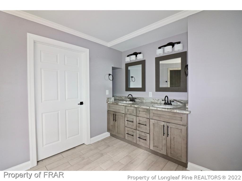 873 Morrison Bridge Road Vass, NC 28394 - Photo 18 of 35 a bathroom with a sink a mirror and a vanity