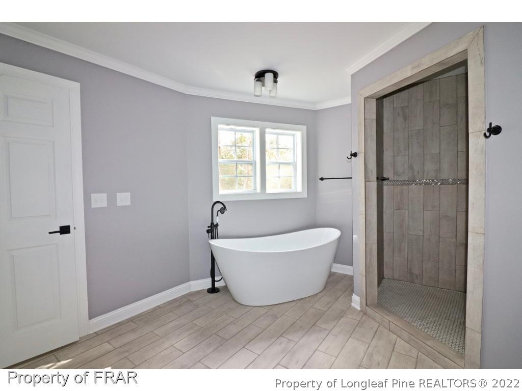 873 Morrison Bridge Road Vass, NC 28394 - Photo 20 of 35 a bathroom with a bathtub and a shower