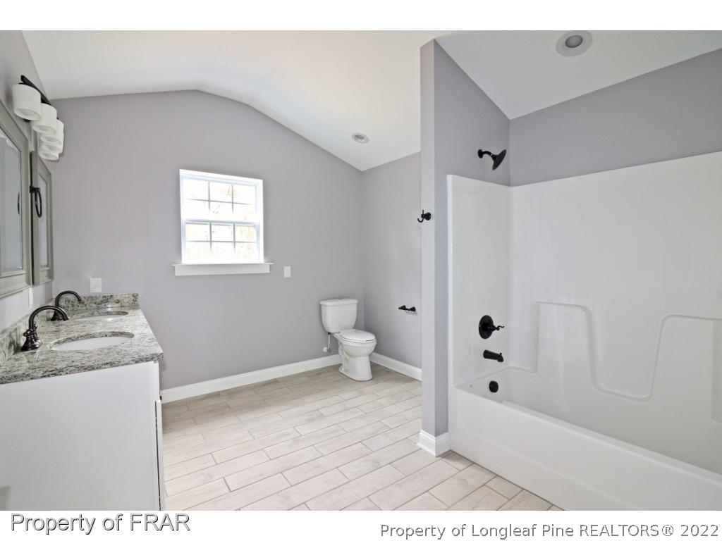 873 Morrison Bridge Road Vass, NC 28394 - Photo 30 of 35 a bathroom with a sink toilet and shower