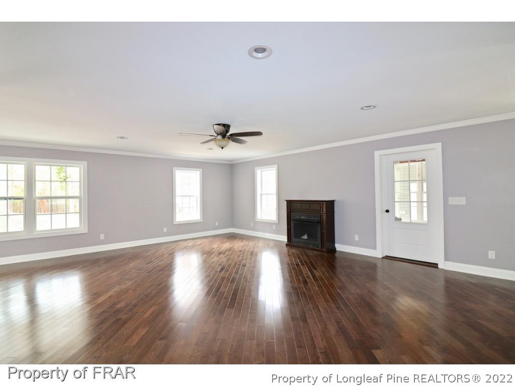 873 Morrison Bridge Road Vass, NC 28394 - Photo 6 of 35 a view of an empty room with wooden floor and a window