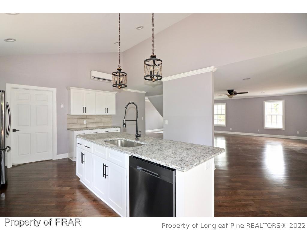 873 Morrison Bridge Road Vass, NC 28394 - Photo 8 of 35 a kitchen with a sink and cabinets
