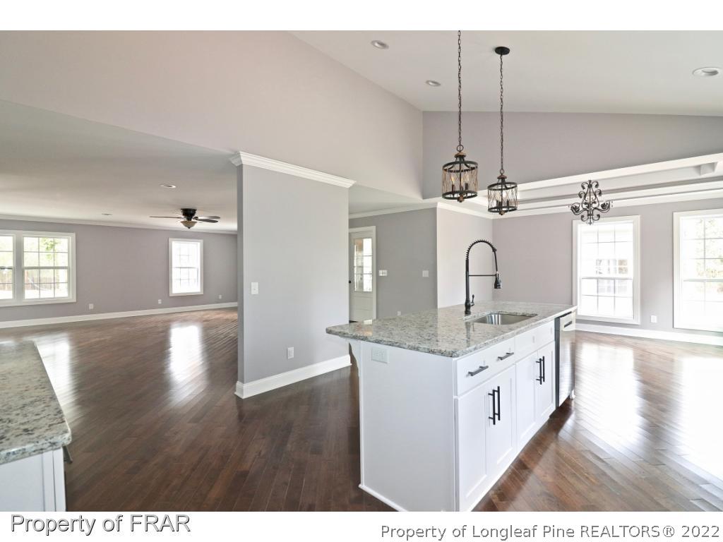 873 Morrison Bridge Road Vass, NC 28394 - Photo 10 of 35 a kitchen with stainless steel appliances granite countertop a sink dishwasher a stove with wooden floor