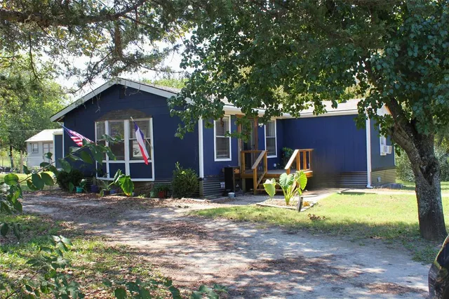 a view of a house with backyard porch and sitting area