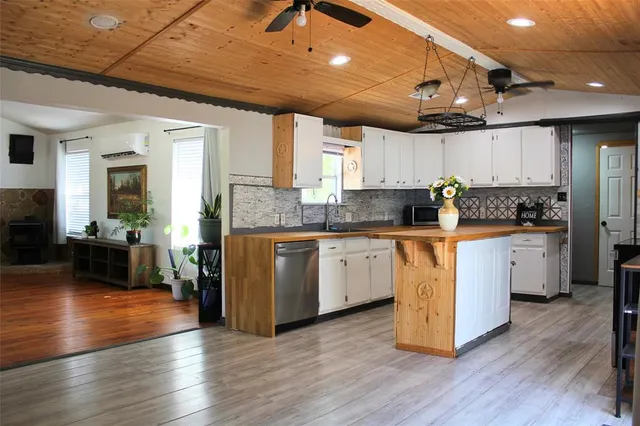 a kitchen with a sink window and cabinets