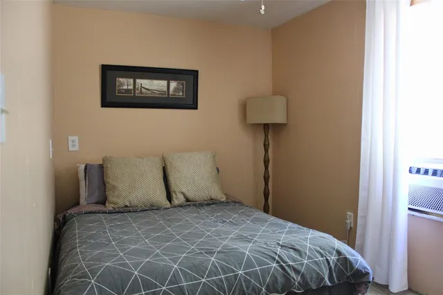 a bedroom with a bed and wall painting