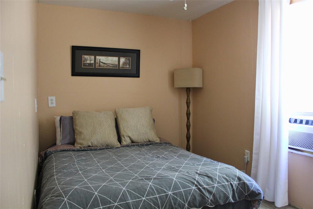 12608 Valverde Loop Terrell, TX 75161 - Photo 16 of 30 a bedroom with a bed and wall painting