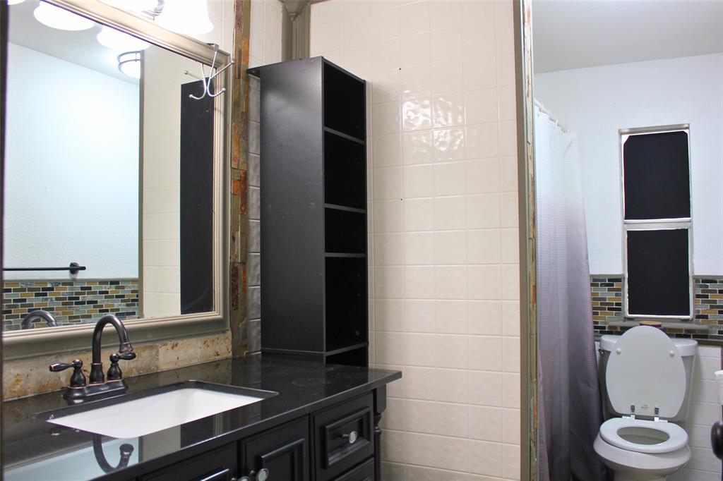 12608 Valverde Loop Terrell, TX 75161 - Photo 17 of 30 a bathroom with a sink a toilet and shower
