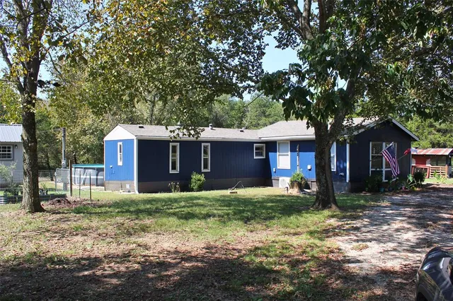 a house that has a tree in front of it