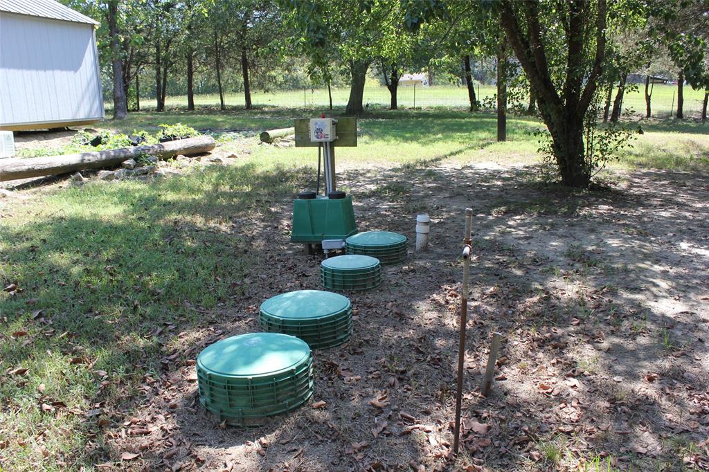 12608 Valverde Loop Terrell, TX 75161 - Photo 24 of 30 a view of a backyard with trees and plants
