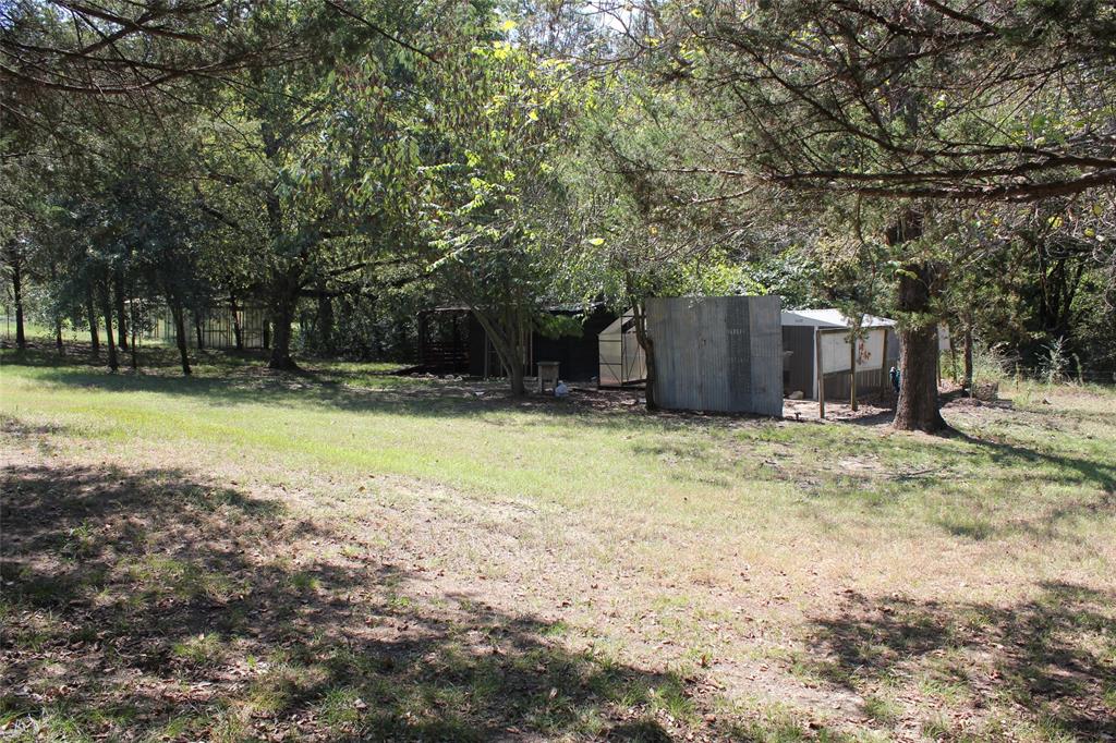 12608 Valverde Loop Terrell, TX 75161 - Photo 25 of 30 a view of a backyard with a small cabin
