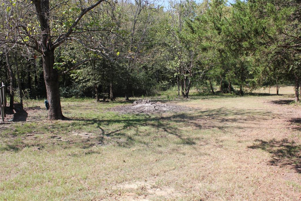 12608 Valverde Loop Terrell, TX 75161 - Photo 26 of 30 a view of dirt yard with a tree