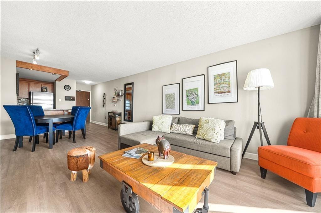 a living room with furniture a rug and a lamp