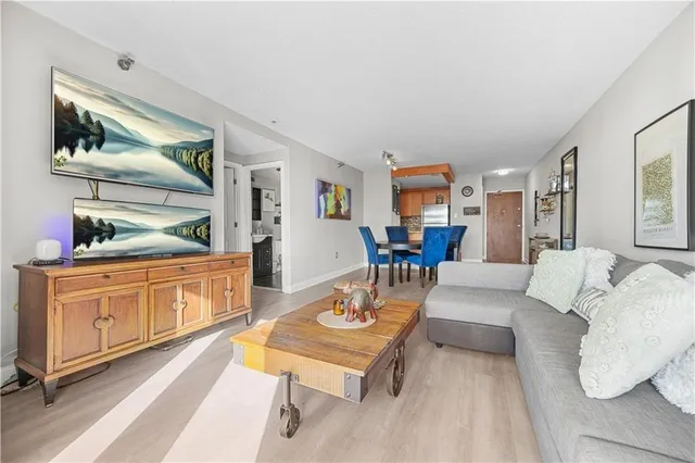 a living room with furniture and wooden floor