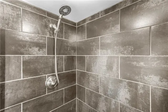 a bathroom with a shower and a mirror