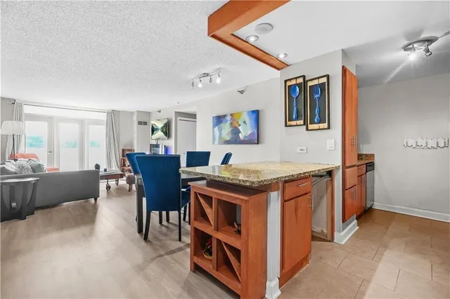 a view of kitchen island with stainless steel appliances granite countertop lots of counter top space