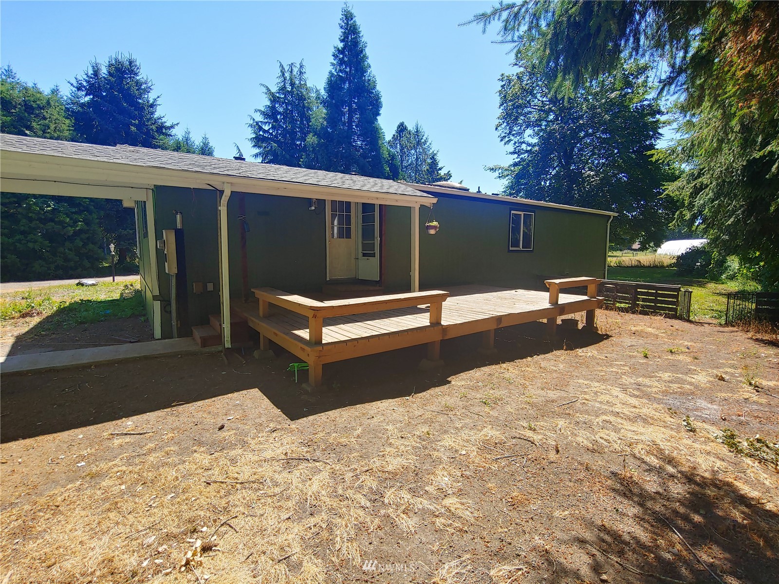 383 Bunker Creek Road Chehalis, WA 98532 - Photo 3 of 35 a backyard of a house with table and chairs