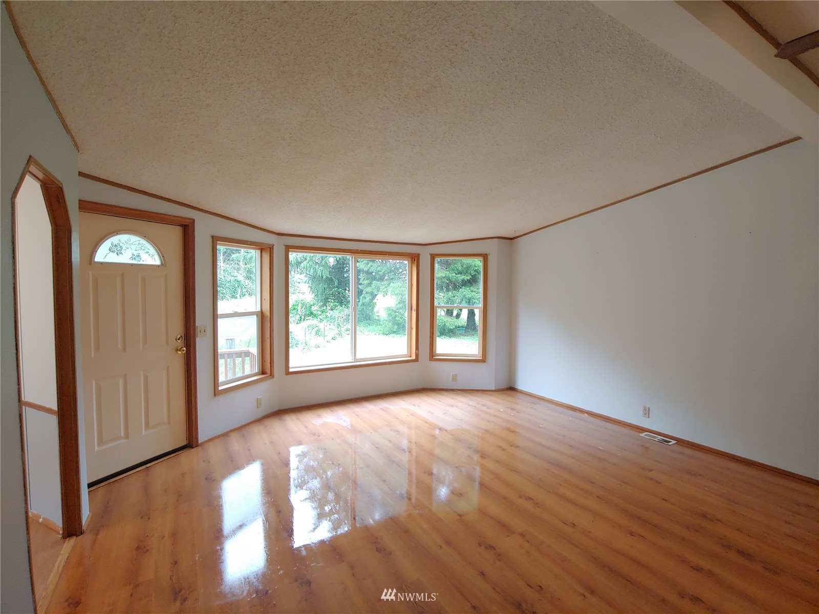 383 Bunker Creek Road Chehalis, WA 98532 - Photo 6 of 35 a view of an empty room with a window and wooden floor