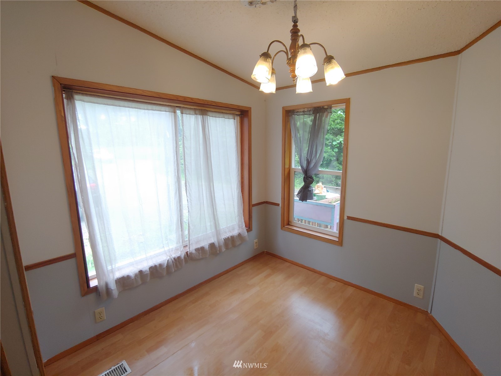 383 Bunker Creek Road Chehalis, WA 98532 - Photo 10 of 35 an empty room with wooden floor and windows