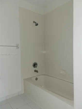 a white toilet sitting next to a white sink