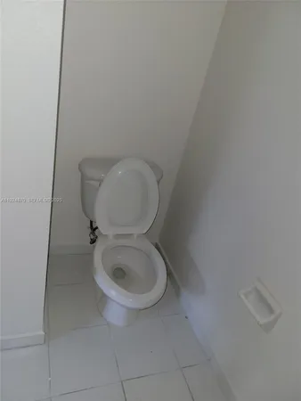a white toilet sitting next to a white sink