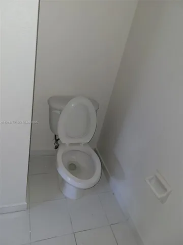 a white toilet sitting next to a white sink