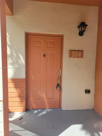 a view of a room with a wooden door