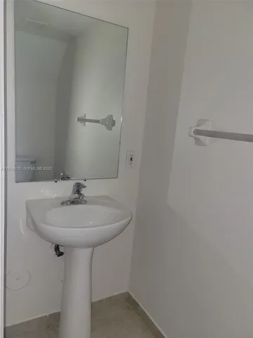 a bathroom with a sink and mirror
