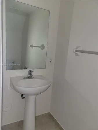 a bathroom with a sink and mirror