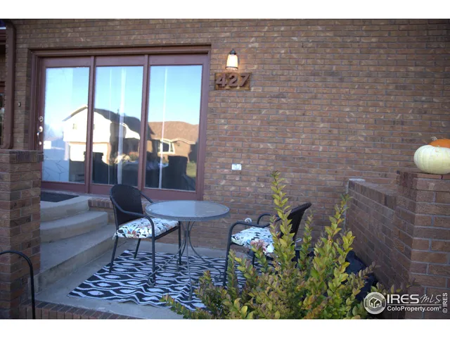 a balcony with table and chairs