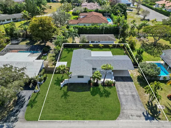 an aerial view of a house with swimming pool garden and patio