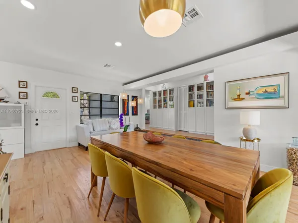 a living room with lots of furniture and view of kitchen