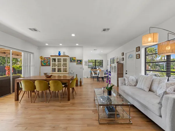 a living room with furniture and wooden floor