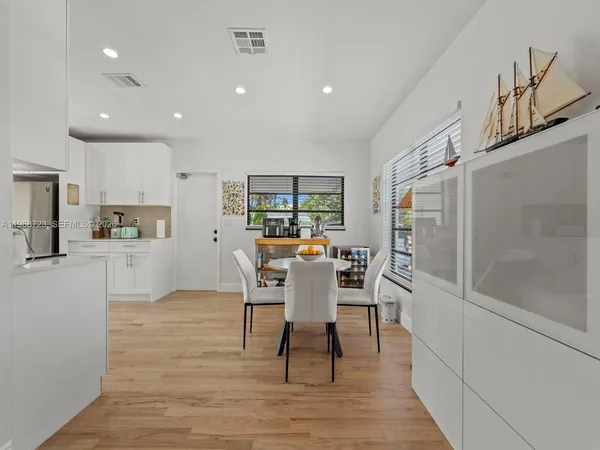 a kitchen with stainless steel appliances a stove top oven a sink a counter space and cabinets