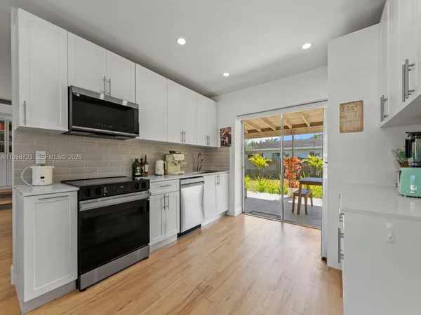 a kitchen with sink stove and cabinets