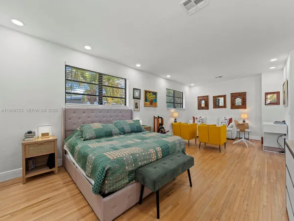 a bedroom with furniture and a flat screen tv