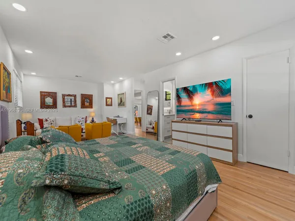a bathroom with a granite countertop toilet sink and mirror