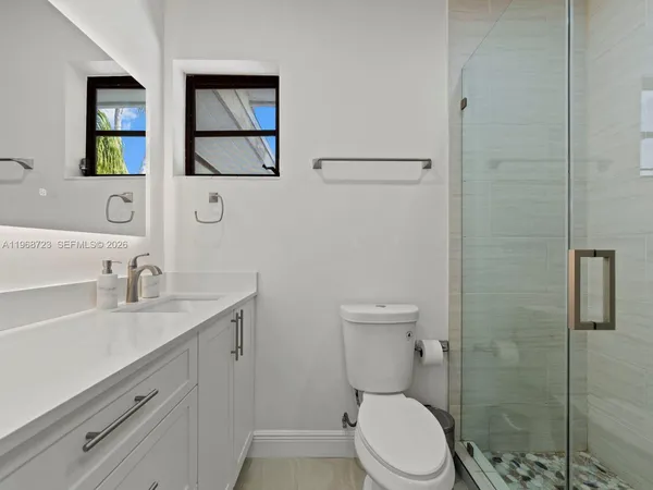 a bathroom with a sink a toilet and mirror