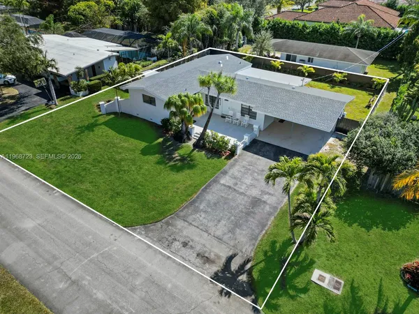 an aerial view of a house with a yard