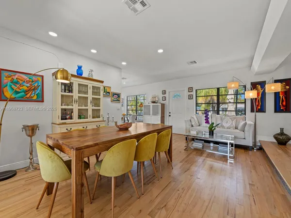 a dining room with furniture and wooden floor