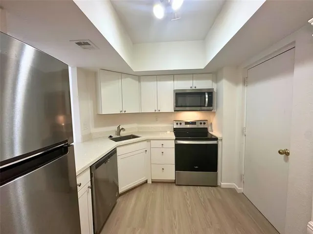 a kitchen with a sink and a stove top oven