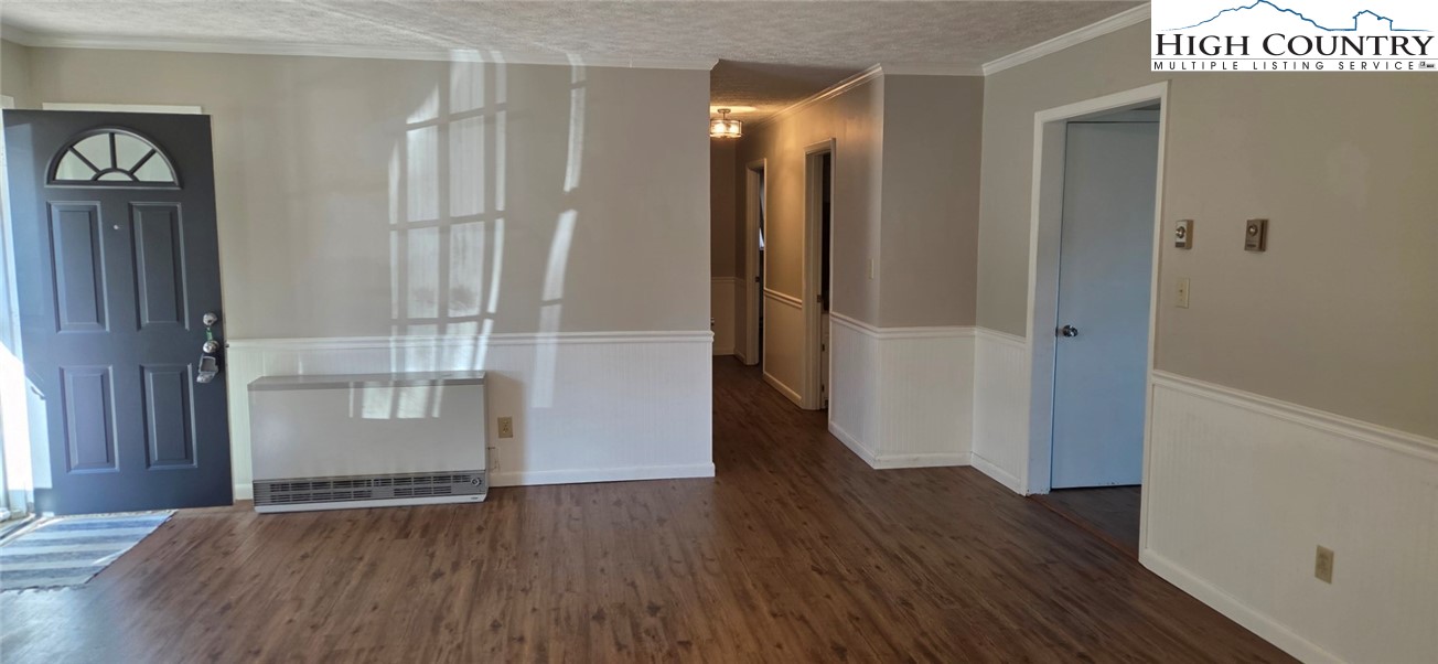 516 White Laurel Lane Boone, NC 28607 - Photo 16 of 27 an empty room with wooden floor and a bathroom
