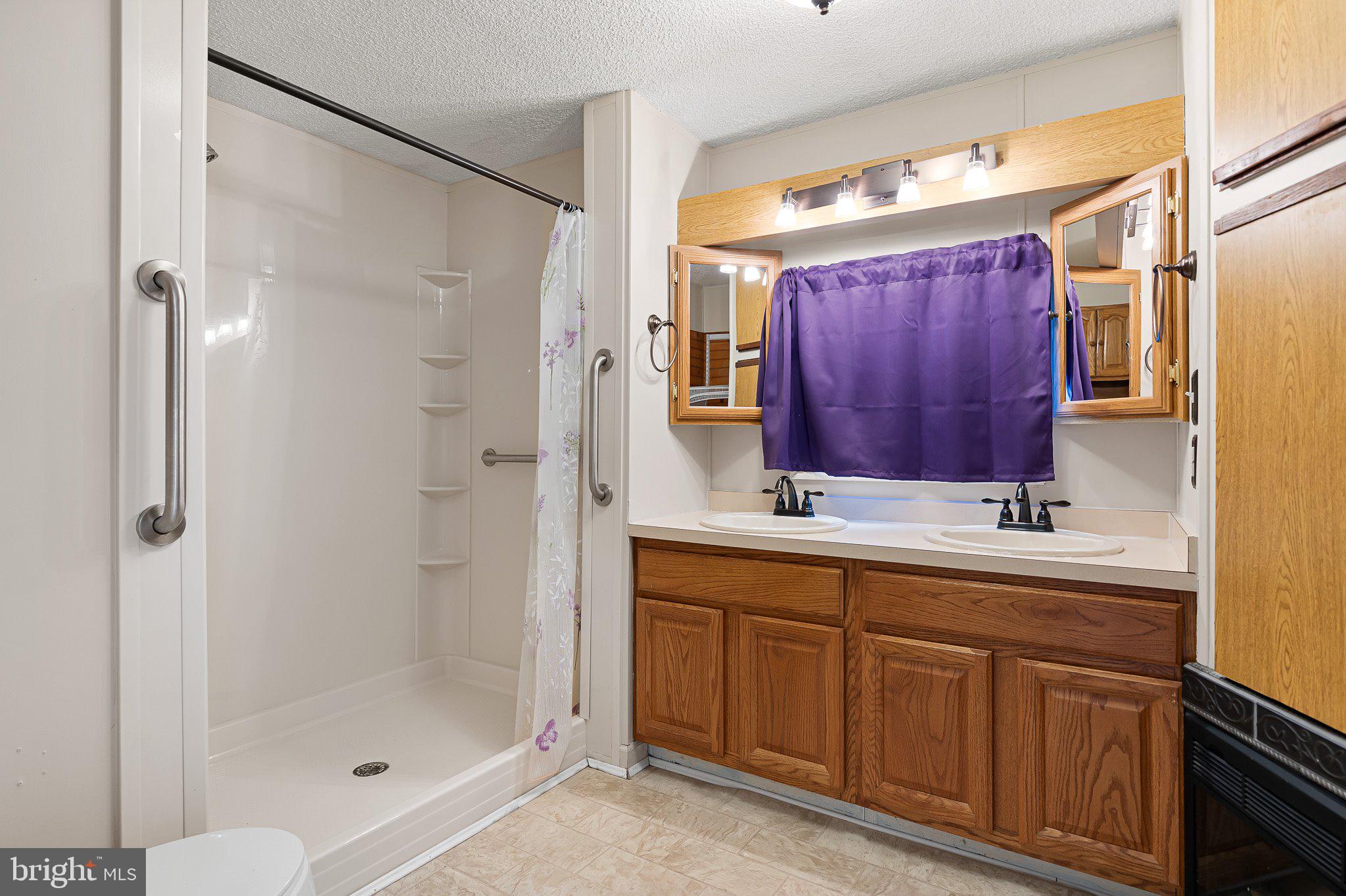 1004 Sulky Road, Unit 225 Wilmington, DE 19810 - Photo 20 of 21 a bathroom with a shower sink and mirror