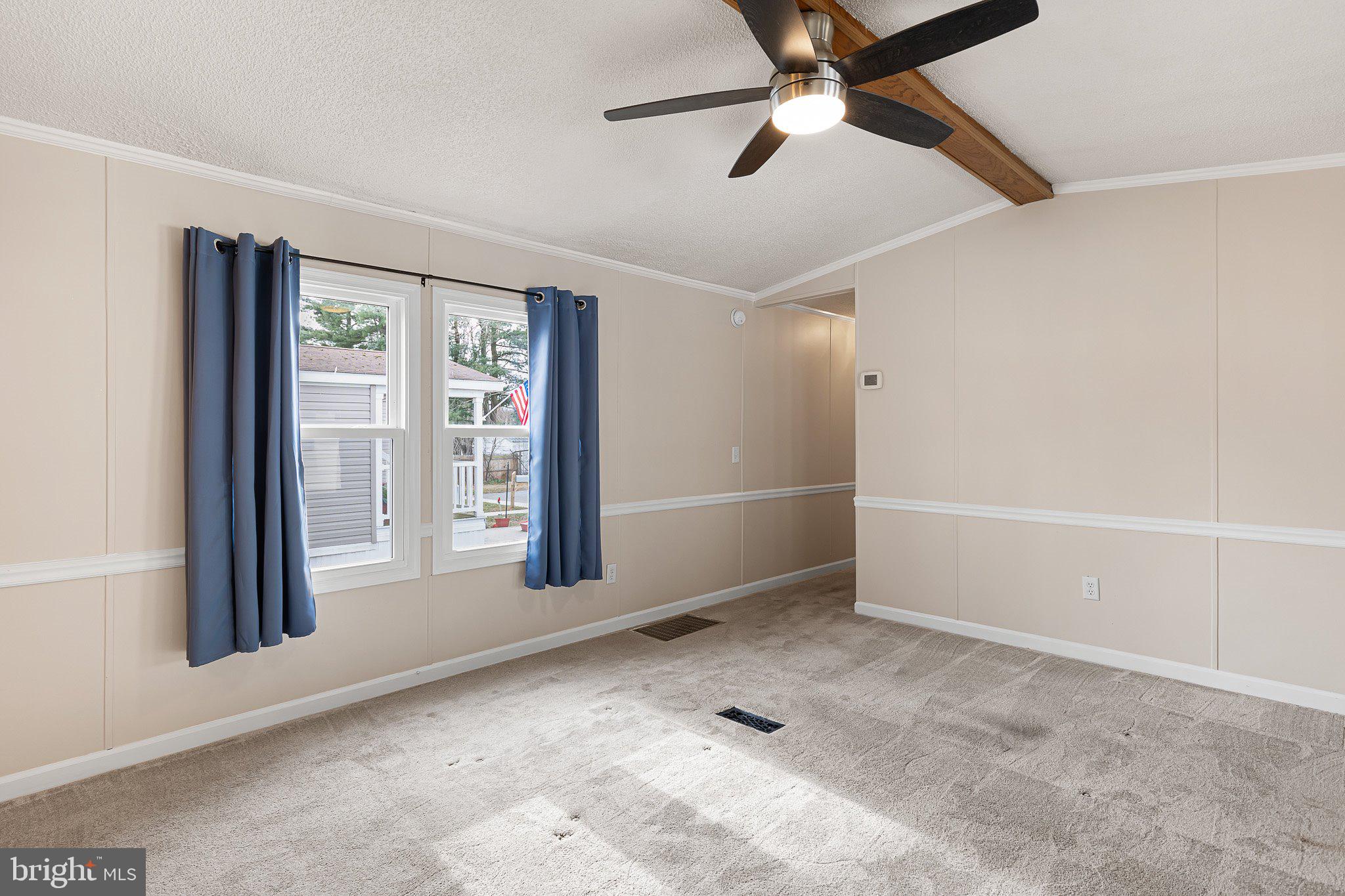 1004 Sulky Road, Unit 225 Wilmington, DE 19810 - Photo 4 of 21 an empty room with windows and ceiling fan