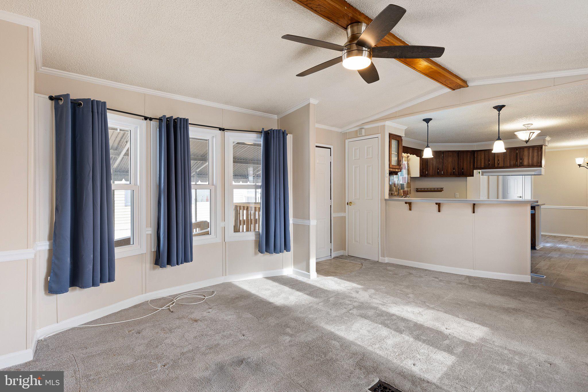 1004 Sulky Road, Unit 225 Wilmington, DE 19810 - Photo 5 of 21 a view of a livingroom with a furniture ceiling fan and window