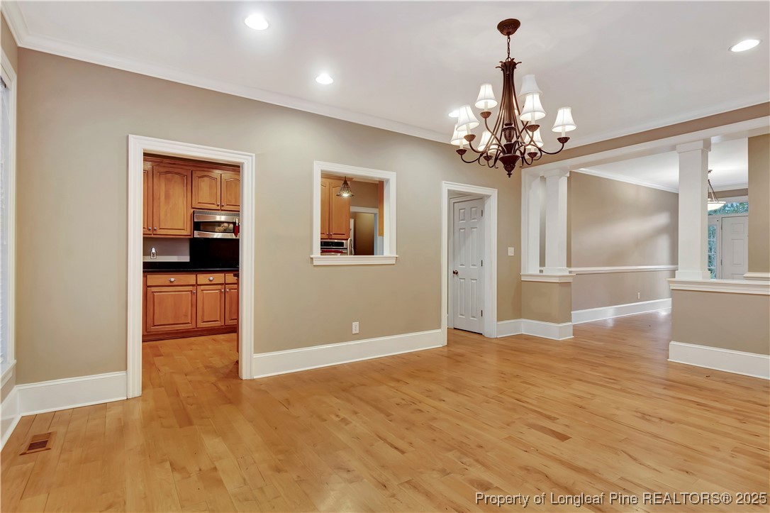 389 Brookgreen Drive Lumberton, NC 28358 - Photo 12 of 44 a view of a livingroom with a chandelier fan and kitchen view