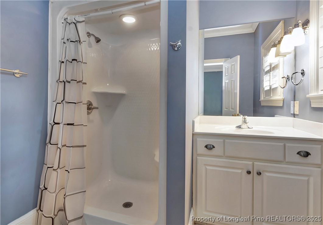 389 Brookgreen Drive Lumberton, NC 28358 - Photo 29 of 44 a bathroom with a shower sink and mirror