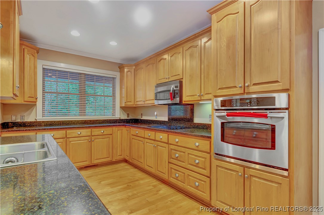 389 Brookgreen Drive Lumberton, NC 28358 - Photo 8 of 44 a kitchen with stainless steel appliances granite countertop a stove a sink and a microwave