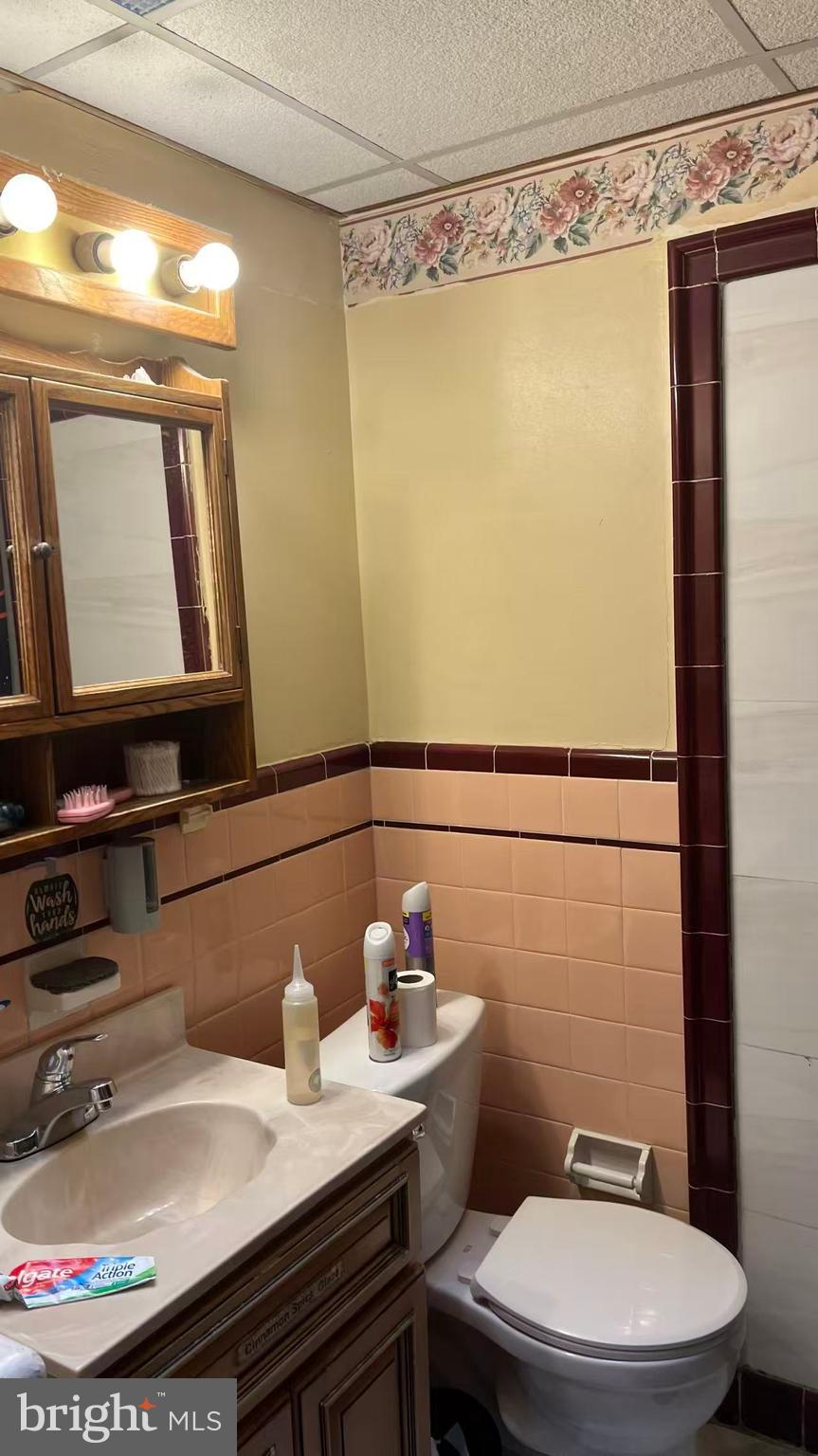 3116 Cottman Avenue Philadelphia, PA 19149 - Photo 6 of 10 a bathroom with a sink a toilet and a mirror