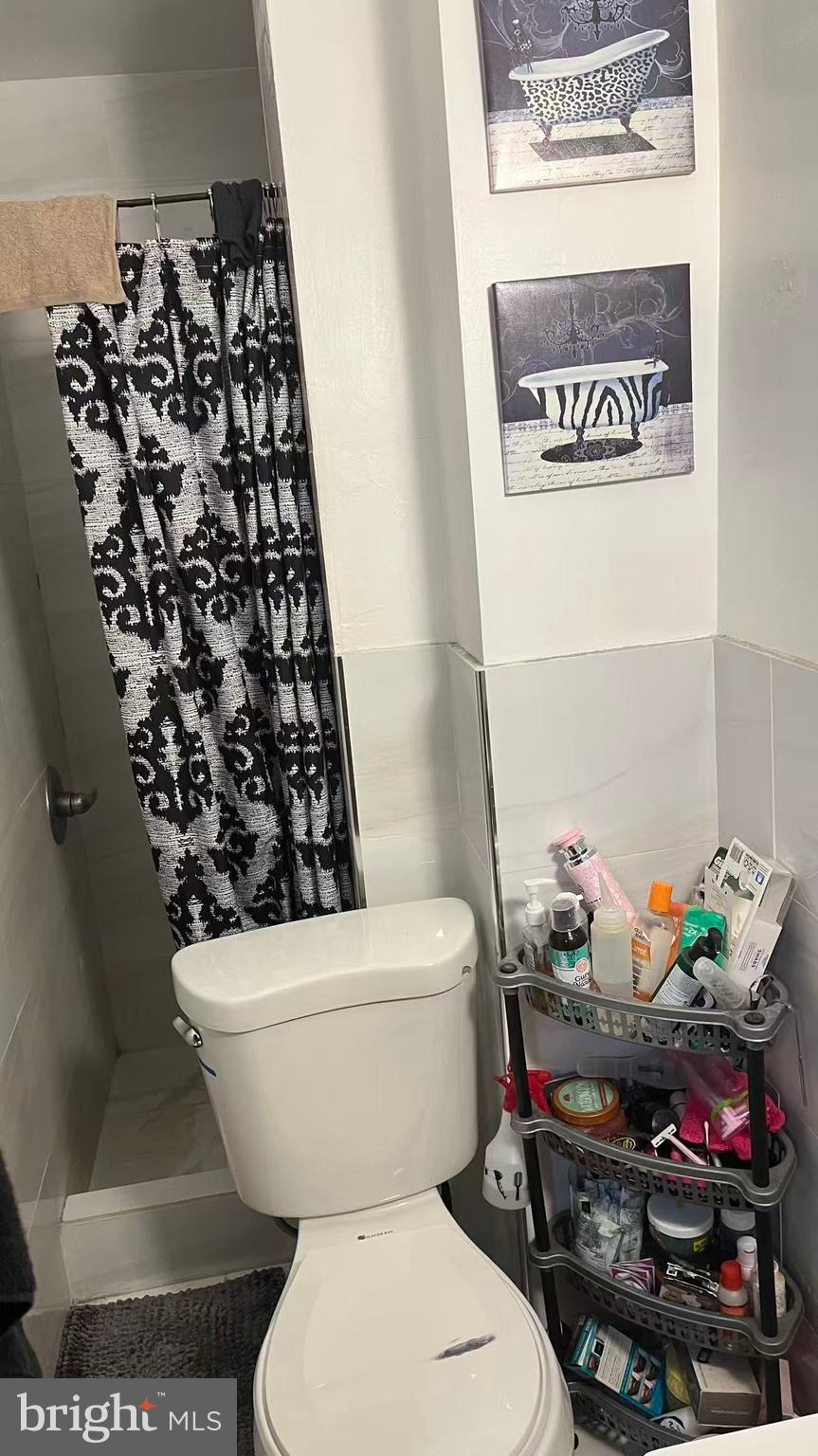 3116 Cottman Avenue Philadelphia, PA 19149 - Photo 8 of 10 a bathroom with a toilet and a shower curtain